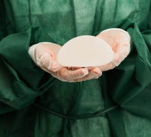 doctor holding breast implant