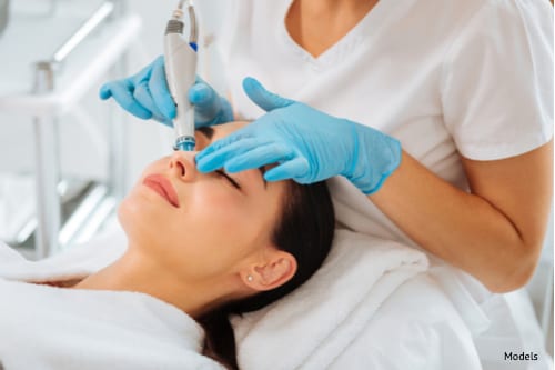 woman getting a hydrafacial from dermatologist