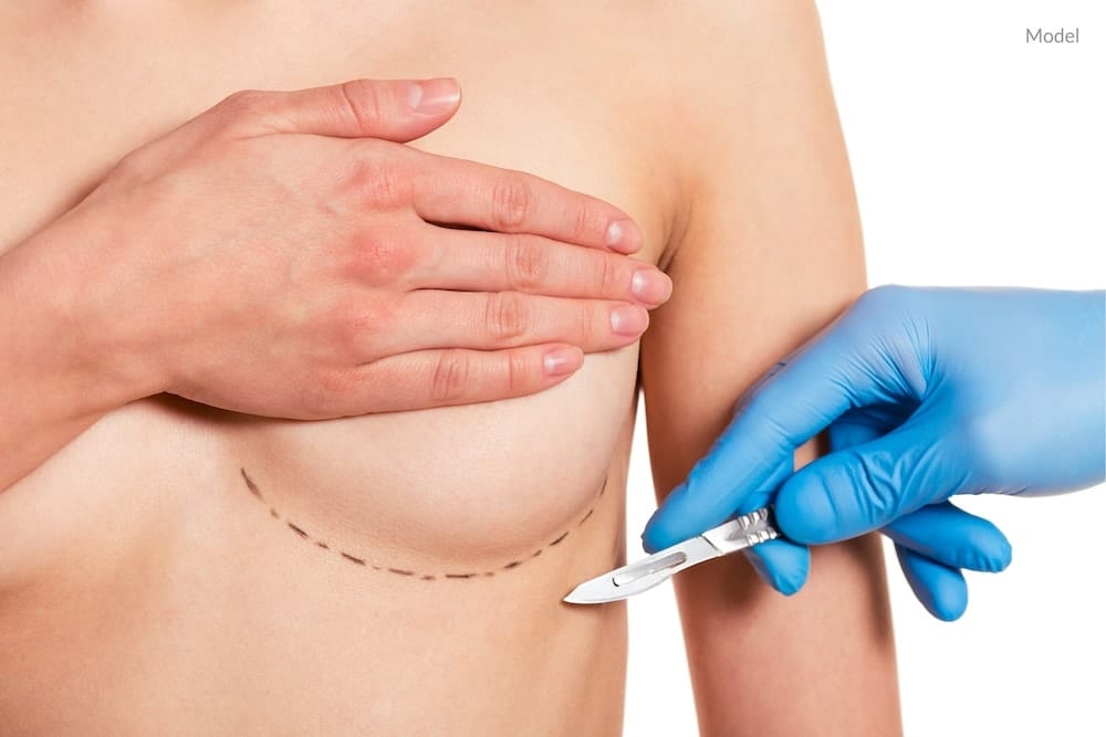 Nurse with operating tools and breast implant.