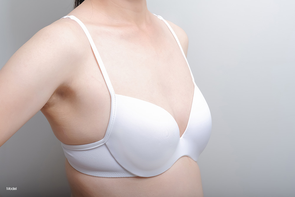 Woman with small breasts in a white bra